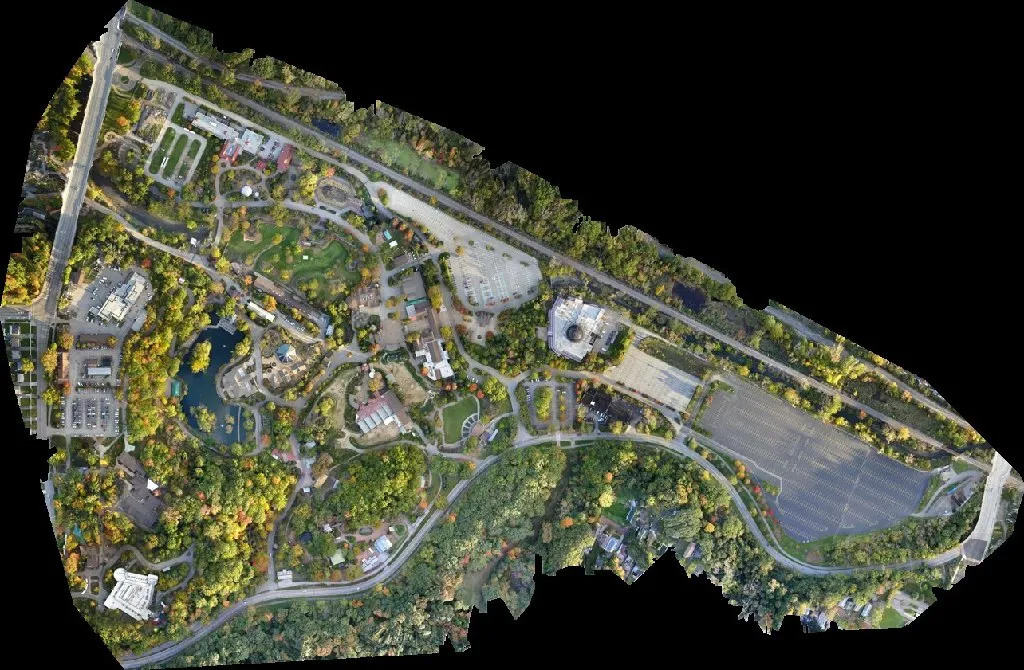 Orthophoto of the Cleveland zoo seen straight down: buildings, paths, parking lots, a pond and trees in autumn colours.